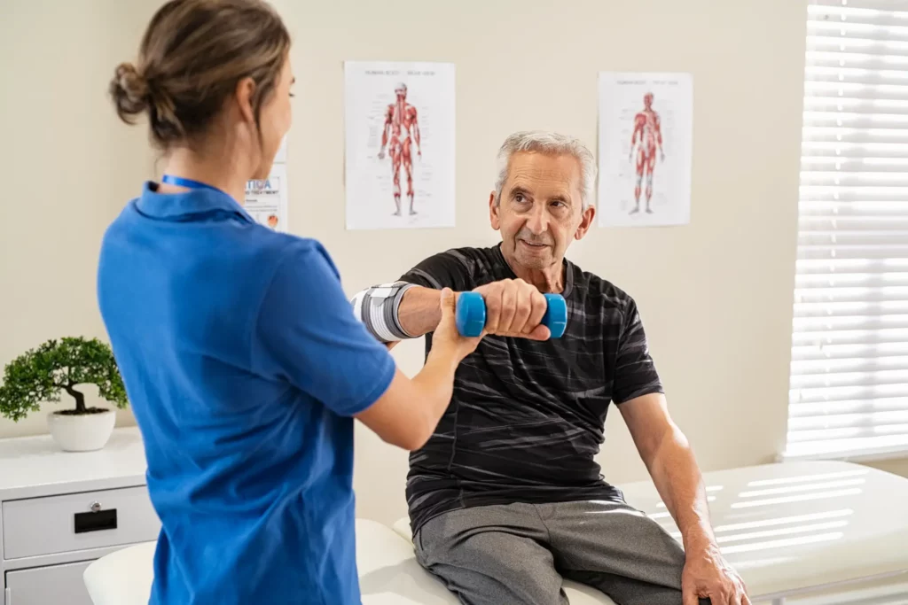 physiotherapist helping senior man exercise 2023 11 27 05 20 51 utc@2x